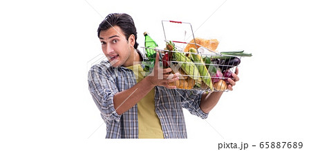 Young man with his grocery shopping on white 65887689