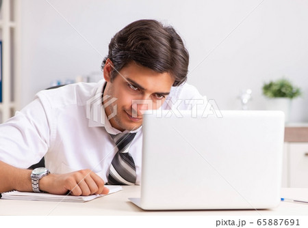 Young handsome businessman working in office 65887691