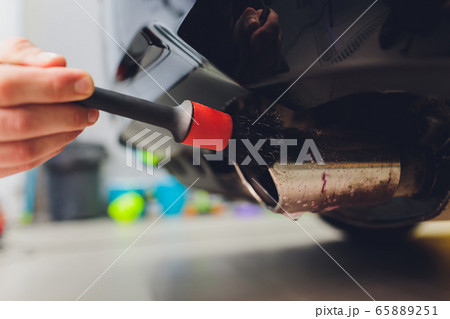 Car exhaust pipe with soap. Car wash background. brushing Car exhaust pipe with soap. Car wash background. brushing 65889251