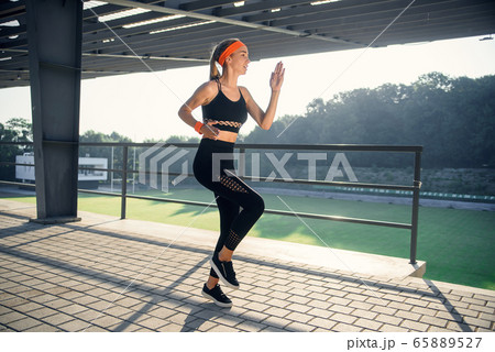 Runner athlete running on stairs. woman fitness jogging workout wellness concept. Runner athlete running on stairs. woman fitness jogging workout wellness concept. 65889527
