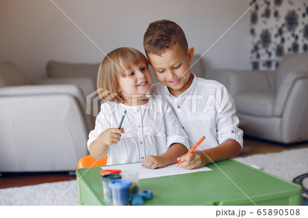 Children siting at the green table and drawing Children siting at the green table and drawing 65890508