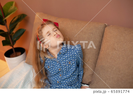Young girl sitting on bed in the bedroom Young girl sitting on bed in the bedroom 65891774
