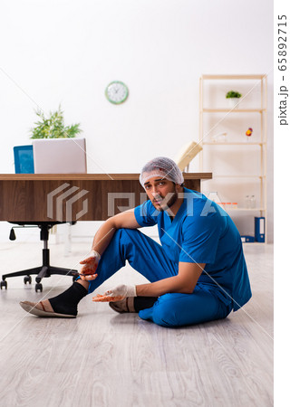 Young male doctor surgeon in fatal negligence concept 65892715