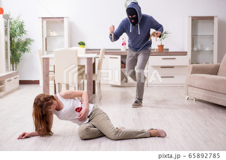 Gangster and young woman in robbery concept Gangster and young woman in robbery concept 65892785