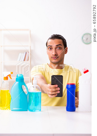 Young male contractor doing housework at home 65892792