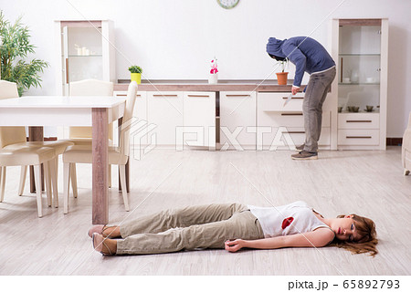 Gangster and young woman in robbery concept 65892793