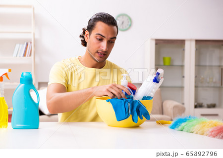 Young male contractor doing housework at home 65892796