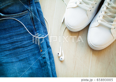Jeans and white sneakers on the store shelf. Jeans and white sneakers on the store shelf. 65893005