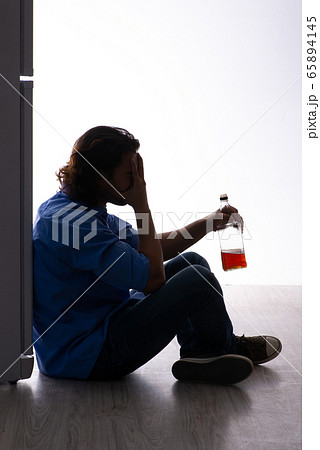 Young man suffering from alcoholism Young man suffering from alcoholism 65894145