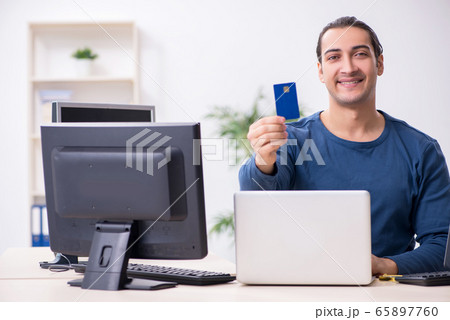 Young male it specialist working in the office Young male it specialist working in the office 65897760