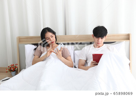 couple love using laptop on bedroom , work couple love using laptop on bedroom , work 65898069