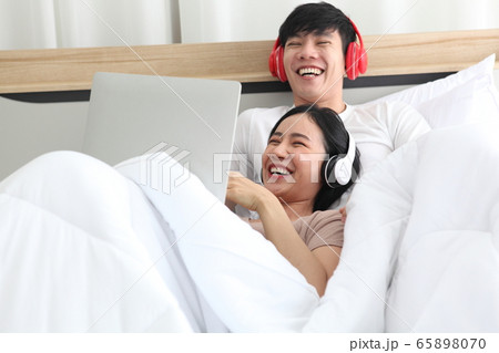 couple love using laptop on bedroom , work couple love using laptop on bedroom , work 65898070