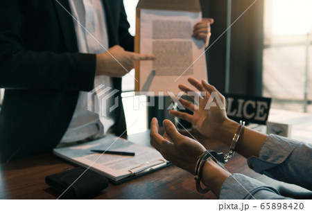 The police officer pointed to the document The police officer pointed to the document 65898420