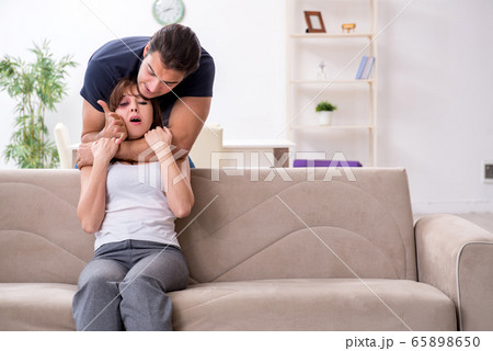 Young couple in domestic violence concept 65898650