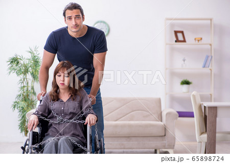 Disabled wife and young husband at home 65898724