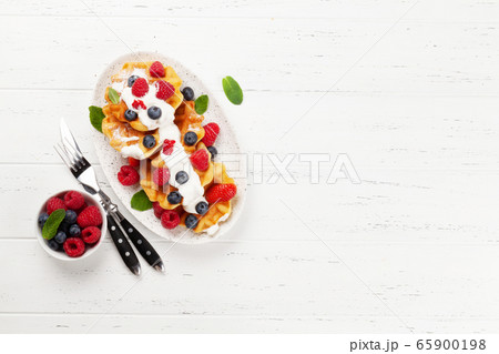 Delicious belgian waffles with summer berries Delicious belgian waffles with summer berries 65900198
