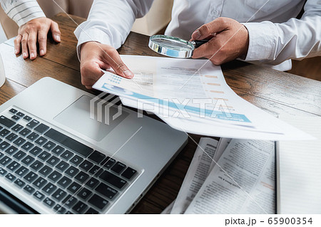 Young unemployed is searching for a job in the newspaper and laptop. Young unemployed is searching for a job in the newspaper and laptop. 65900354