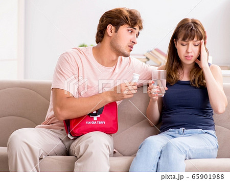 Young family getting treatment with first aid kit 65901988