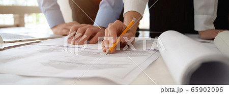 Two engineers consulting on their project with 65902096