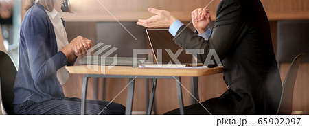 Male financial adviser consulting with female 65902097