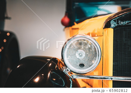 Close Headlamp Of Yellow Retro Vintage Oldtimer Car 65902812