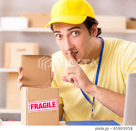 Handsome contractor working in box delivery relocation service Handsome contractor working in box delivery relocation service 65903058