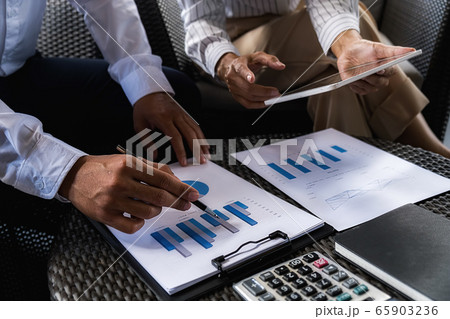 Business team brainstorming and discussing with financial data and report graph. Business team brainstorming and discussing with financial data and report graph. 65903236