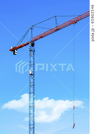 Tower crane and building construction on a background of blue sky Tower crane and building construction on a background of blue sky 65903546