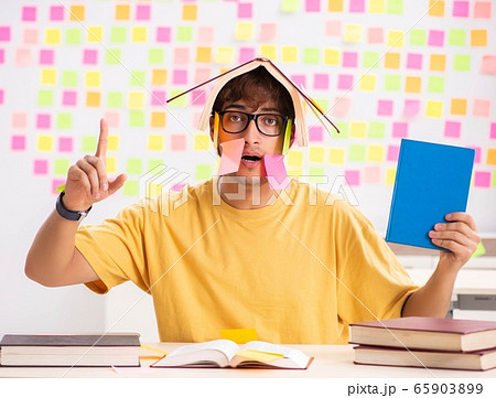 Student preparing for exams with many conflicting priorities 65903899