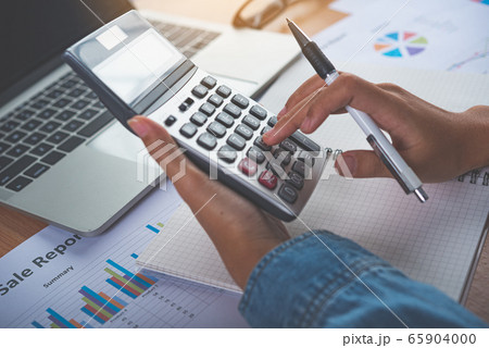 The accountant's hand is using the calculator.  65904000