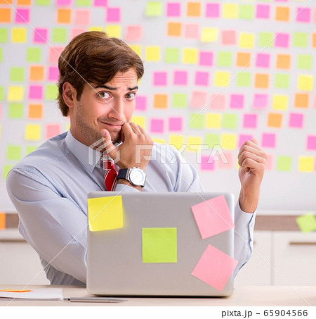 Young handsome man in conflicting priorities concept Young handsome man in conflicting priorities concept 65904566