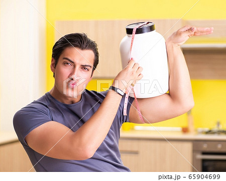 Young man blogging about food supplements Young man blogging about food supplements 65904699