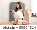 Cute asian woman wash hands with gel alcohol to prevent coronavirus  before preparing for breakfast in kitchen. 65904814