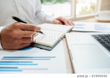 Businessman discussing the charts and graphs showing the results of their successful teamwork. 65906080