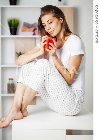 Cute girl with a beautiful smile in new pajamas getting ready for bed Cute girl with a beautiful smile in new pajamas getting ready for bed 65910365