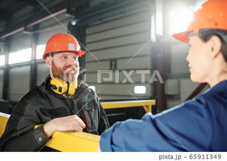 Chatting with colleague during break Chatting with colleague during break 65911349