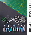 sewing items on a black background from above 65913479