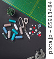 sewing items on a black background from above 65913484