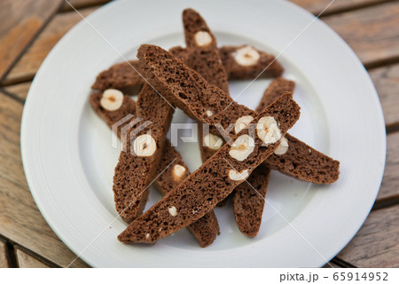 chocolate Homemade biscotti with nuts on a white plate on a wooden table 65914952