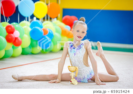 Beautiful little gymnast training on the carpet and ready for competitions Beautiful little gymnast training on the carpet and ready for competitions 65915424