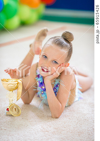 Beautiful little gymnast training on the carpet and ready for competitions 65915426