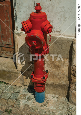 Red hydrant next to plaster wall in Portalegre Red hydrant next to plaster wall in Portalegre 65915707