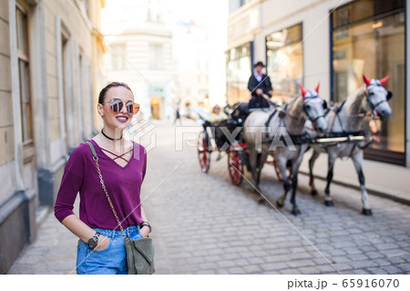 Woman walking in city. Young attractive tourist outdoors in italian city Woman walking in city. Young attractive tourist outdoors in italian city 65916070