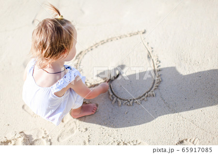 Adorable little girl have fun at tropical beach during vacation Adorable little girl have fun at tropical beach during vacation 65917085