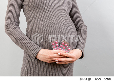 Close up of pregnant woman holding maternal Close up of pregnant woman holding maternal 65917206