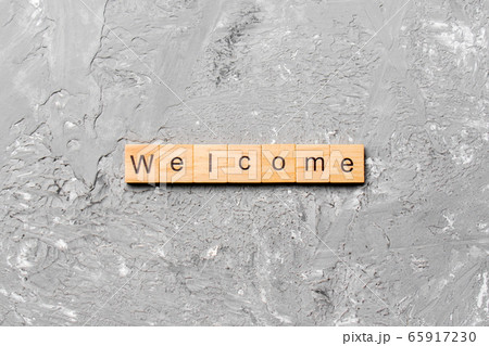 WELCOME word written on wood block. WELCOME text 65917230