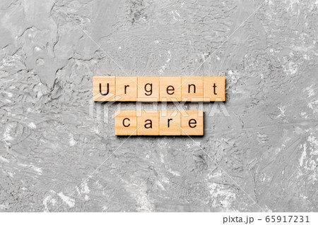 Urgent care word written on wood block. Urgent 65917231