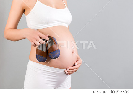 Close up portrait of pregnant woman in white Close up portrait of pregnant woman in white 65917350