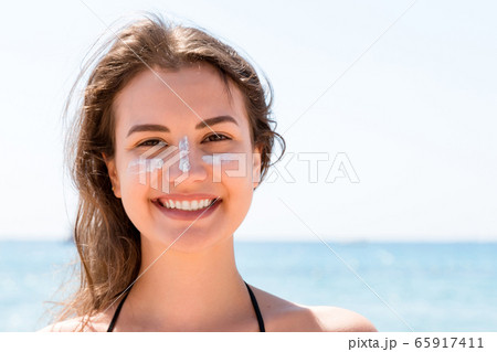 Beautiful young woman is posing at the camera with 65917411