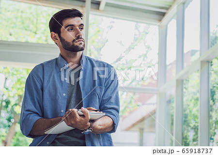A man thinking and writing his idea at note book A man thinking and writing his idea at note book 65918737